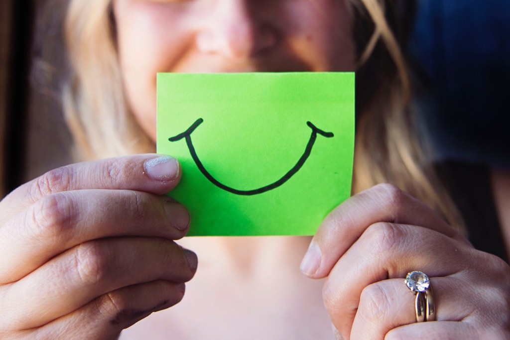 Woman with post-it with smile